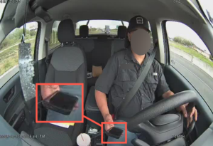 driver with phone in hand